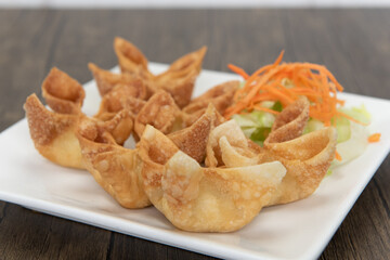 Deep fried ranggoon wontons filled with delicious stuffings and presented in a star shape on a plate