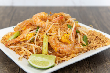 Large pile of bean sprouts and stir fried vegetables topped with spicy thai shrimp for that delicious explosion of flavor