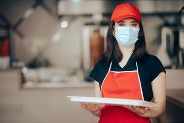 Fast Food Restaurant Worker Wearing Face Mask Holding a Tray