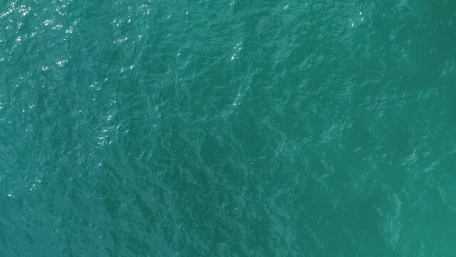 Hovering Over the Vivid Blue Ocean Water as Ripples Pass