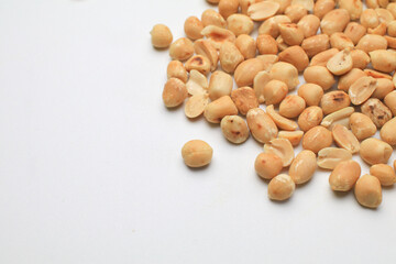 Roasted peanuts isolated on white background, clipping path, full depth of field. Selective focus