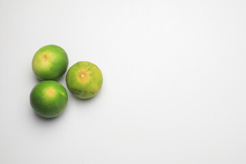 Fresh lime isolated on white background. Texture pattern juicy green tropical lime fruit. Image green limes
