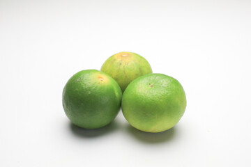 Fresh lime isolated on white background. Texture pattern juicy green tropical lime fruit. Image green limes