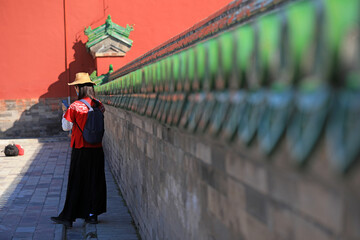 Female tourists play in the classical architecture of the temple of heaven in Beijing
