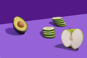 Set of green fruits and vegetables on a violet background. Copy space