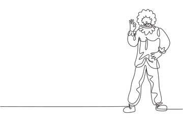 Single continuous line drawing clown stands with gesture okay wearing wig and clown costume ready to entertain the audience in circus arena. Dynamic one line draw graphic design vector illustration