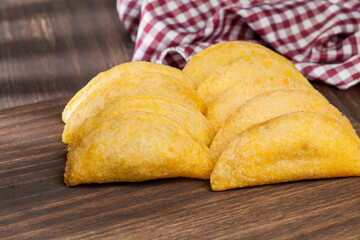 Tasty empanadas - Colombian cuisine; photo on wooden background