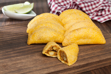 Tasty empanadas - Colombian cuisine; photo on wooden background