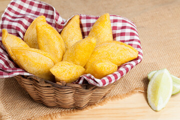 Tasty empanadas - Colombian cuisine; photo on wooden background
