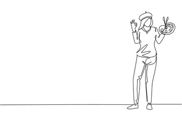 Single continuous line drawing female painter stands with gesture okay using hat and painting tools to produce artwork in his workshop studio. Dynamic one line draw graphic design vector illustration