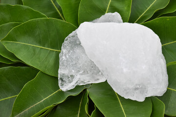 Alum cubes on leaves background, concept for herb, bodycare, skincare, waterclear and protect...