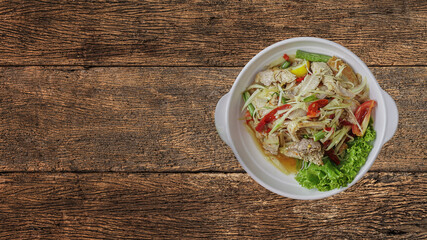Som Tum or Thai spicy fresh young papaya salad with grilled pork