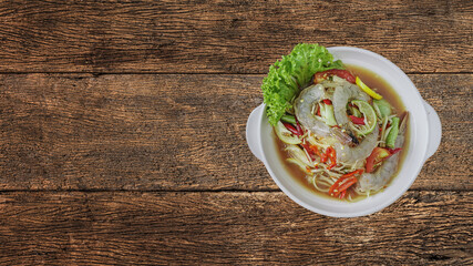 Som Tum or Thai spicy fresh young papaya salad with raw fresh shrimp