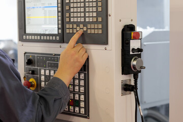 operator prepares CNC machine for a new task