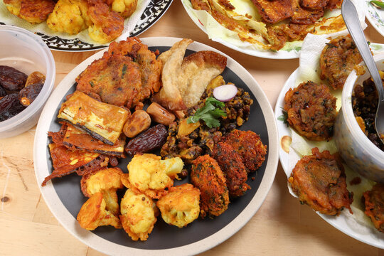 Indian Bengali stye variety fitter deep fried tanpura piaju pakoda battered cauliflower eggplant dumplings chola dal fry dates for iftar breakfast snack comfort food