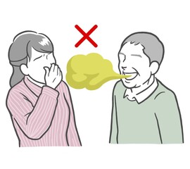 口臭がきつい中年男性と鼻をつまむ若い女性