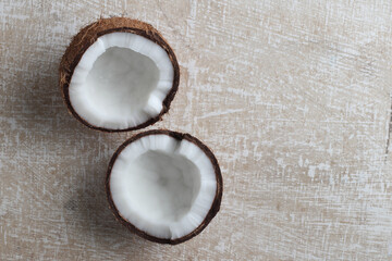 Half cut coconut on a wooden base.