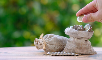 Saving money concept- money bag on table,and business growth concept, finance and investment conce