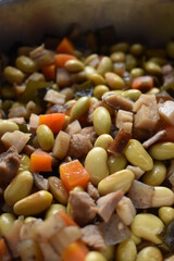 Cooked soy beans with various vegetables in a pot. gomoku nimame. Japanese food.