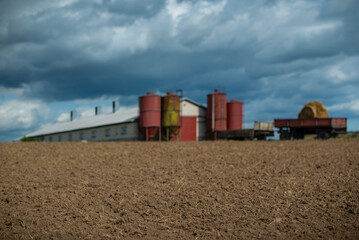 Fototapeta na wymiar Farm Field Background with blurred Barn