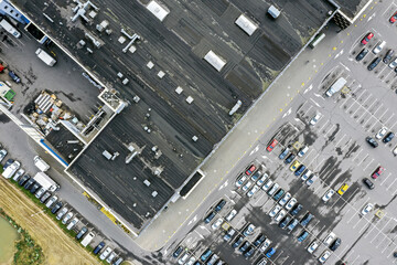 aerial top view of city shopping mall with cars at parking area. drone photo