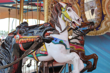 Fototapeta na wymiar Vintage Carousel horses at rural carnival or fair