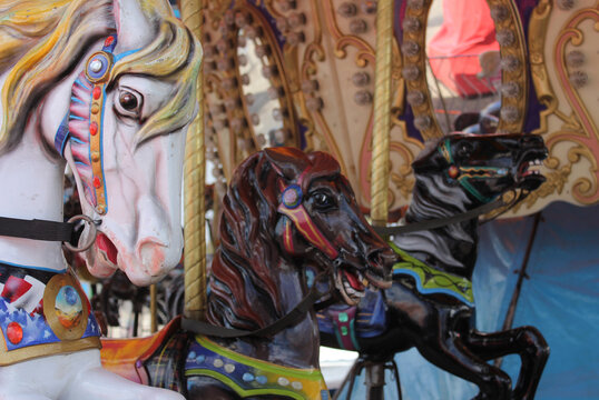 Vintage Carousel horses at rural carnival or fair