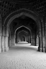 Fototapeta na wymiar Ancient Mughal era corridor. Location- Inside jamali kamali mosque in Archaeological Village complex in Mehrauli. Citu- New Delhi, Country- India. 15 January 2017.