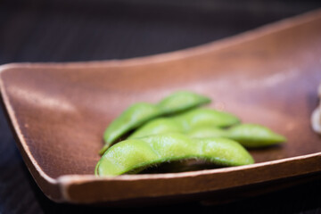 Edamame or green soybeans blanched at japanese restaurant.