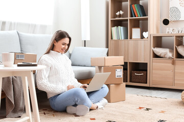 Young woman using laptop at home