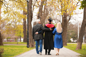 Young man with his parents on graduation day