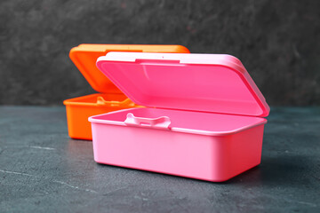 Plastic lunch boxes on dark background