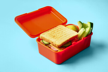Lunch box with tasty food on color background
