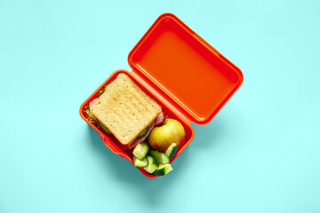 Lunch box with tasty food on color background