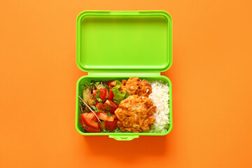 Lunch box with tasty food on color background