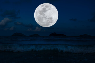 Fototapeta na wymiar Full moon on sky over sea in the night.