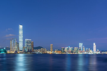 Fototapeta na wymiar Panorama of skyline of Victoria harbor of Hong Kong city at dusk