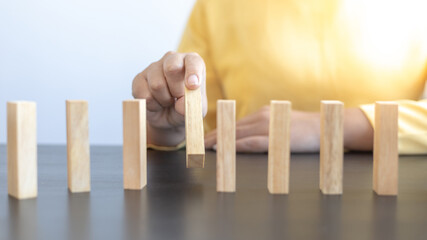 Strategies and risks of wooden games, Close-up of business people gambling with investment risk, Business people play wooden games to simulate planning and strategy for managing business risk.