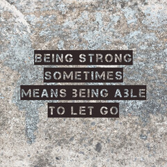 Inspirational motivating quote on background, "Being strong sometimes means being able to let go."