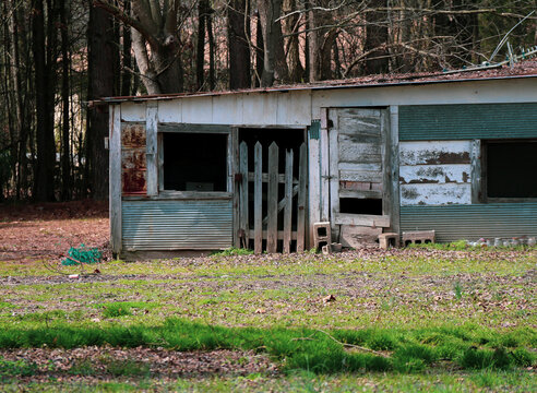 old empty abandoned shed farm building made with spare parts and falling apart rundown deserted