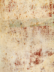 texture of an old metal garage wall exposed to weather and with rust and peeling paint
