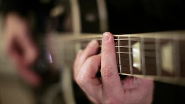 guitarist plays in first position super shallow depth of field