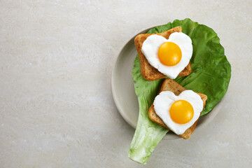 Heart shaped egg in tosted slice of rye bread ceramic plate. Love breakfast design. Healthy...
