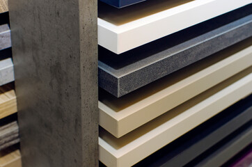 Stack of samples of laminate for the production of furniture, close-up.