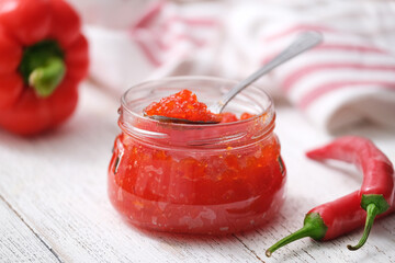 Hot pepper jelly. Sweet bell pepper and chili pepper sauce, confiture, jam in a glass jar.
