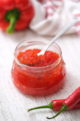 Hot pepper jelly. Sweet bell pepper and chili pepper sauce, confiture, jam in a glass jar.