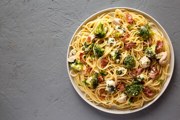 Homemade Chicken Bacon Broccoli Alfredo on a plate on a gray background, top view. Flat lay, overhead, from above.