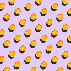 Repetitive pattern made of dry orange slices on pink background
