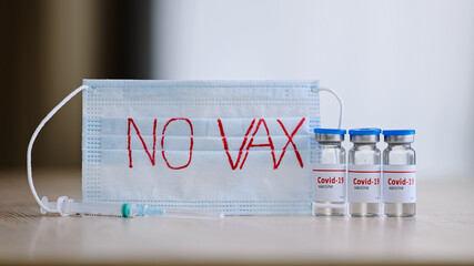 Close-up transparent glass bottles with liquid vaccine medicine anti-covid-19 coronavirus on table...