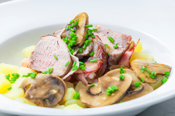 veal roll in bacon with mushroom sauce and potatoes